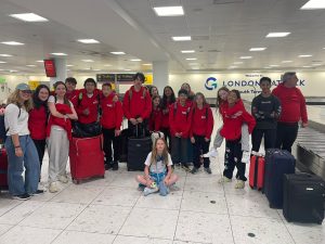 Hounslow Jets in the airport with their luggage. 