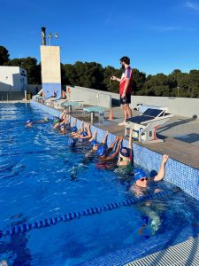 Hounslow Jets in the outdoor swimming pool with clear blue skies of Spain.