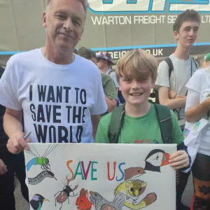 Logan holding a poster at a protest