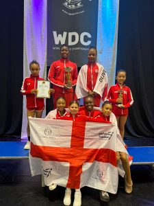 Group photo of Deborah Day Theatre School Trust holding England flag