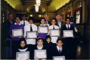 Group photo of young people holding certificates and Sir Jack